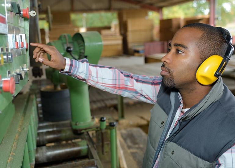 Man working at control panel in factory High Point NC